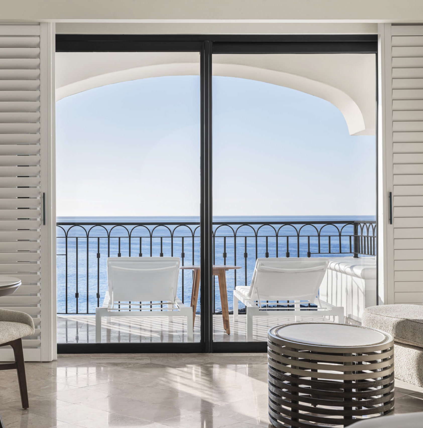 picture of a sea view balcony with two chairs and a small round table